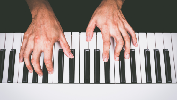 Hands playing the piano