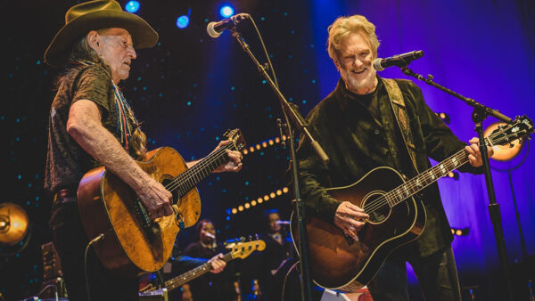 Kristofferson playing guitar on stage