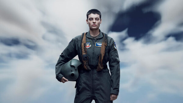 a solider standing in front of a blue sky