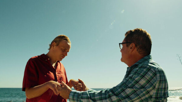 Two people daning together in front of the ocean from 