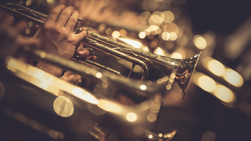 A close up of a trumpet being held in someone's hands