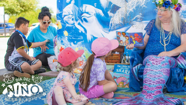 Families finger paint and read books at the Día Del Niño Celebration in Somerton, Arizona
