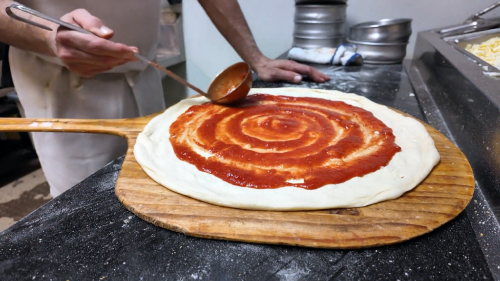 A pizza being made from La Famiglia Pizza