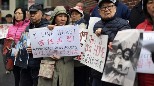 A group of people standing together with signs