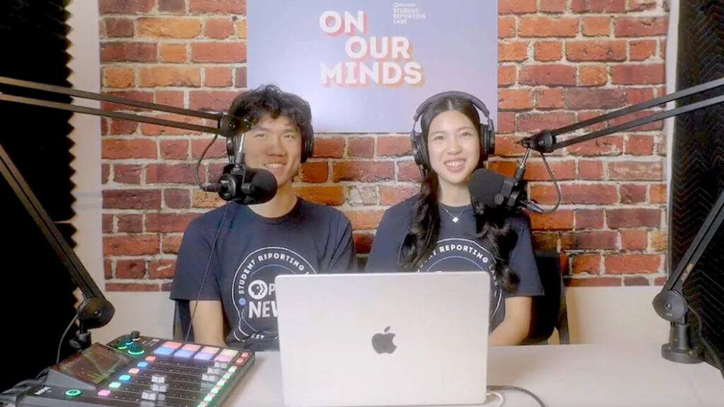 Teens talk into mics on the podcast 