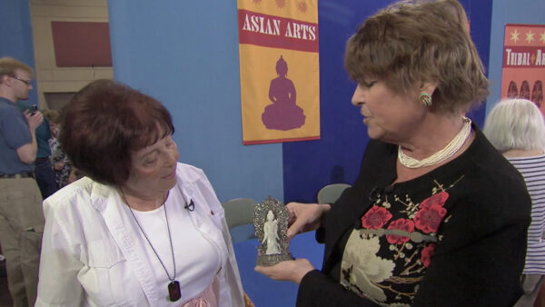 Two women looking at an small figure