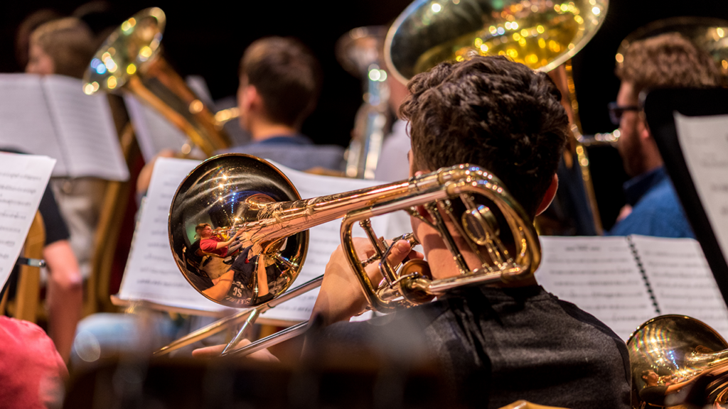 A trombone player from behind