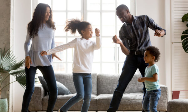 A family dances inside