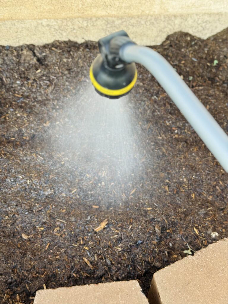 A hose watering a garden

