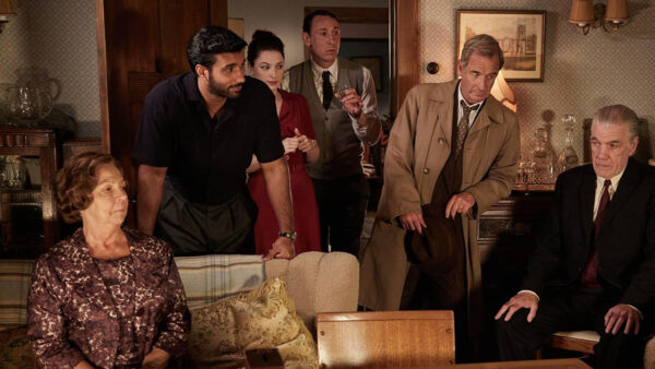 The cast of Grantchester gathered around the living room talking
