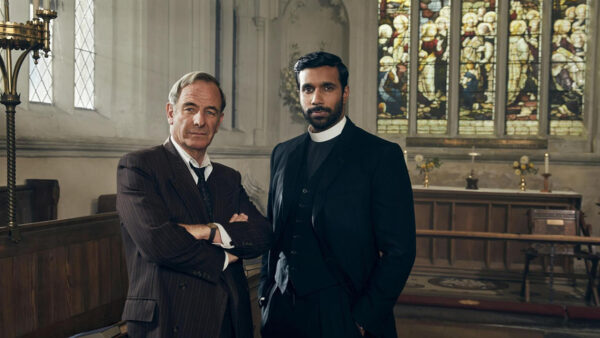 The cast of Grantchester standing in a church
