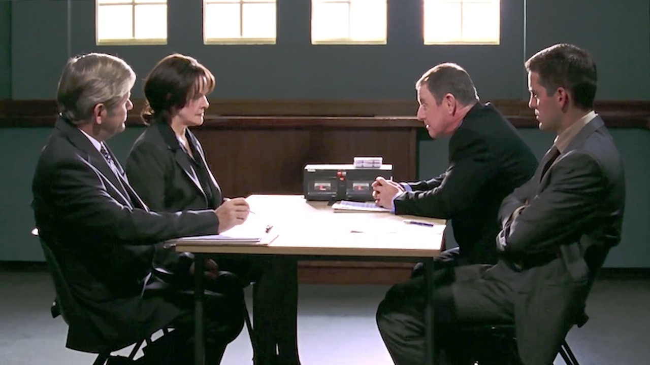 Inspector Barnaby and Dan Scott sit at a table interrogating a witness with their lawyer present