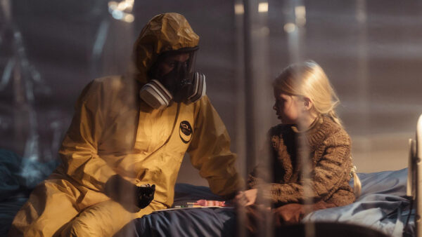A woman in a suit speaking with a child