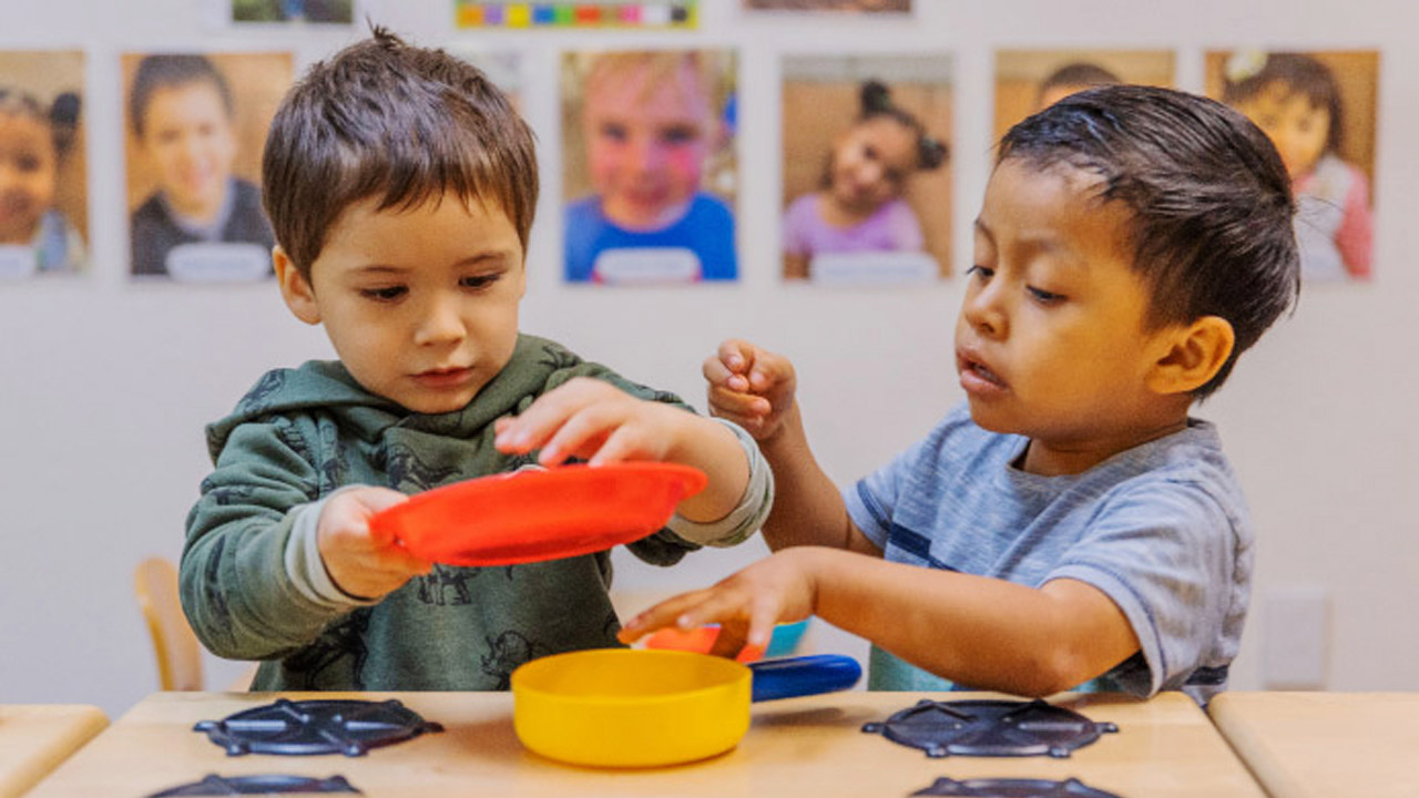 Two young boys learning to share their toys