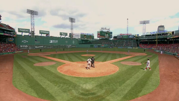 Baseball game at Fenway Park with players on the field, focusing on home plate.