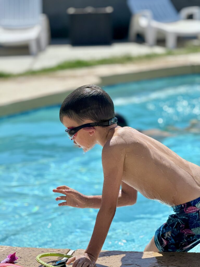 A boy next to a pool