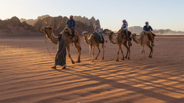 couple and world champion kayakers Emily Jackson and Nick Troutman riding on the back of camels with their two kids