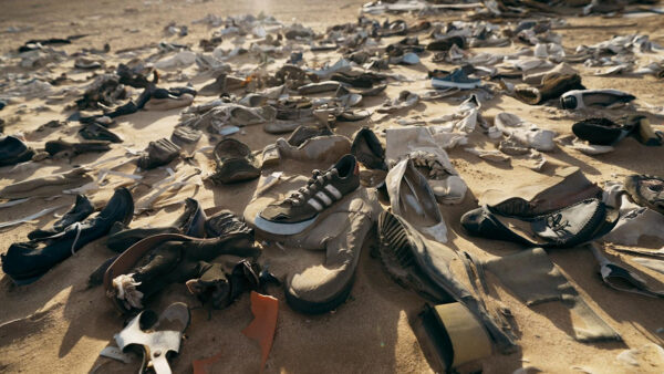 A pile of shoes spread out in a dump