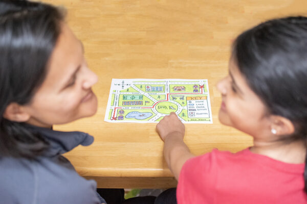 A child shows their parent a map