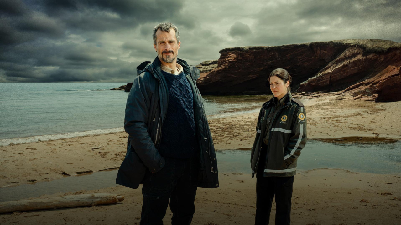 Two detectives standing on a windy beach