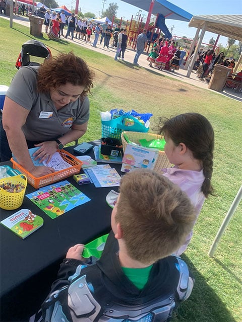 Several people gather around a table