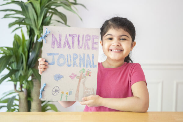 A girl shows off her nature journal