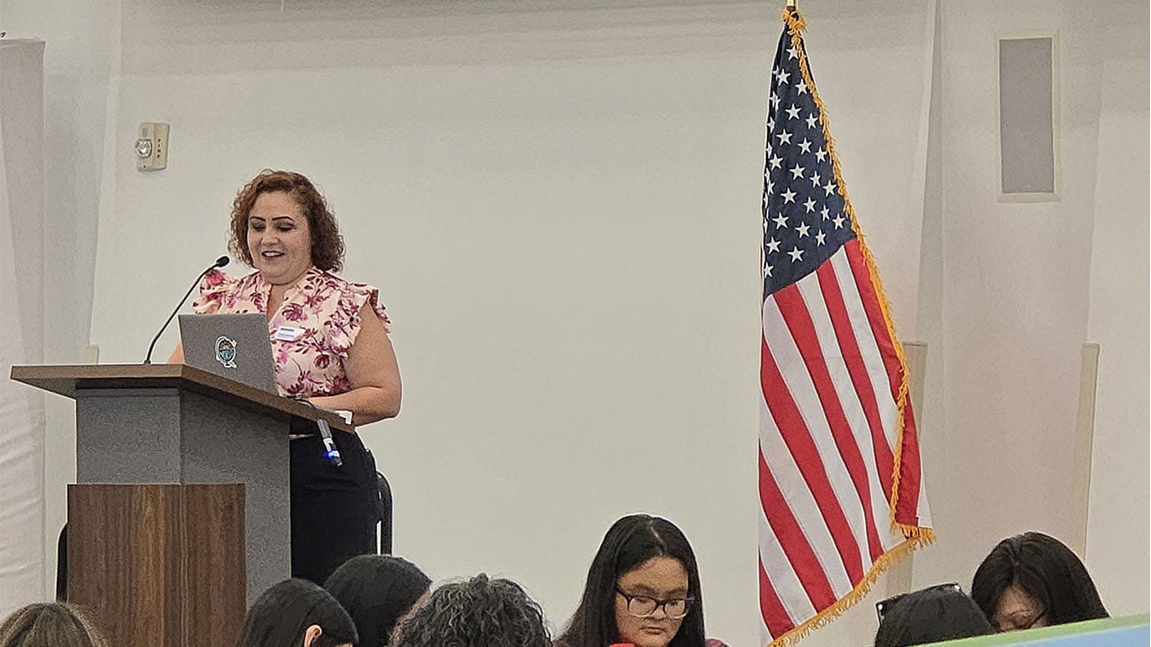 A woman speaks at a podium