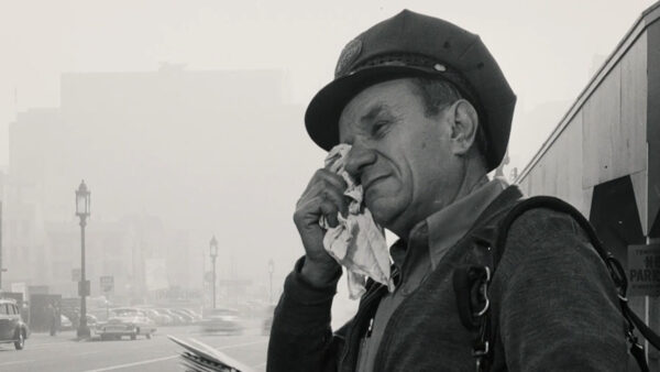 A man trying to clear his eyes due to the intense smog in LA