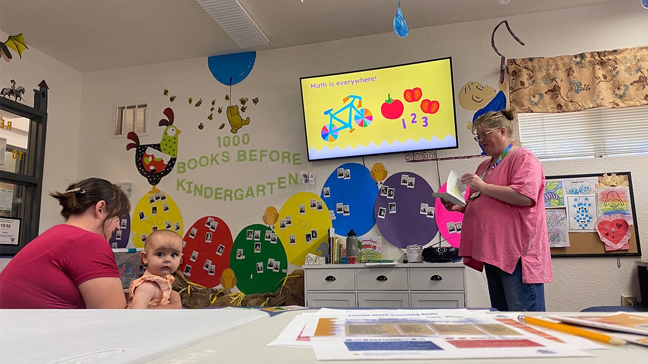 A woman and a kid engage in a classroom