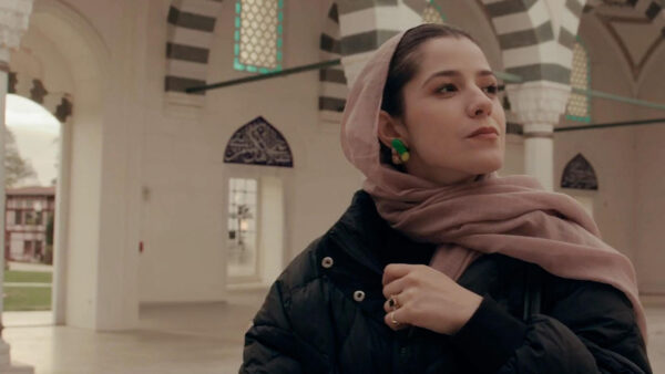 A women exploring a building to understand the history the Islam