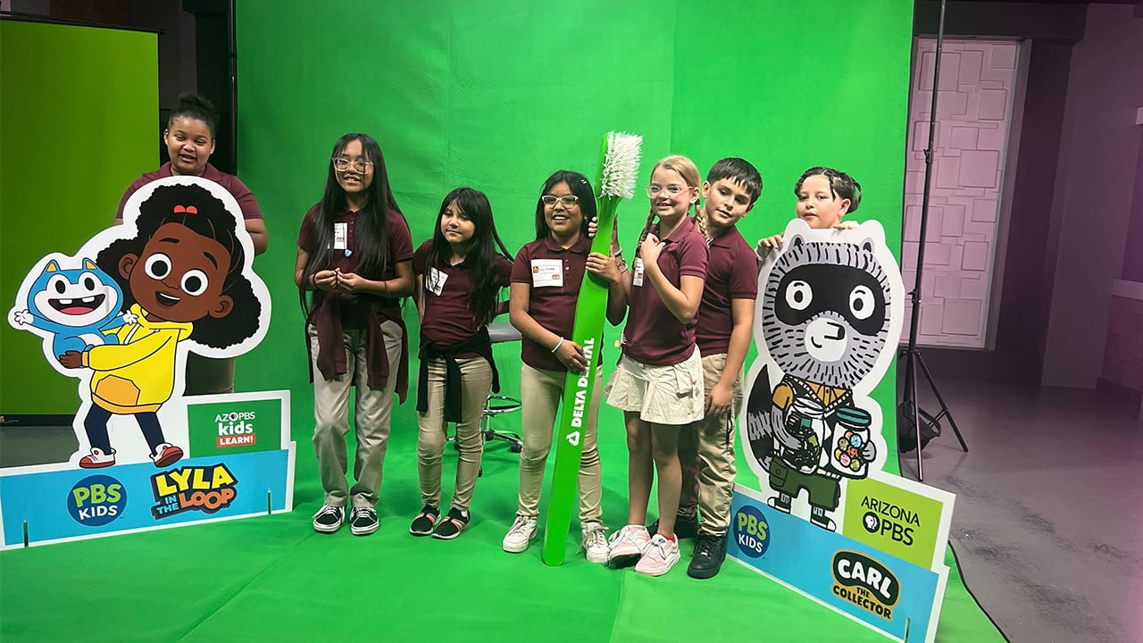 Several kids happily posing together for a photo