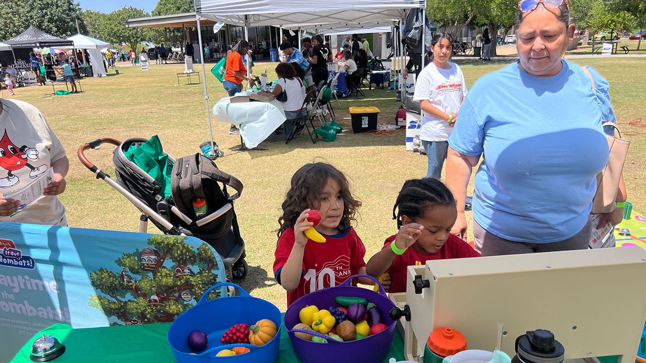 A woman and two children enjoying an outdoor event