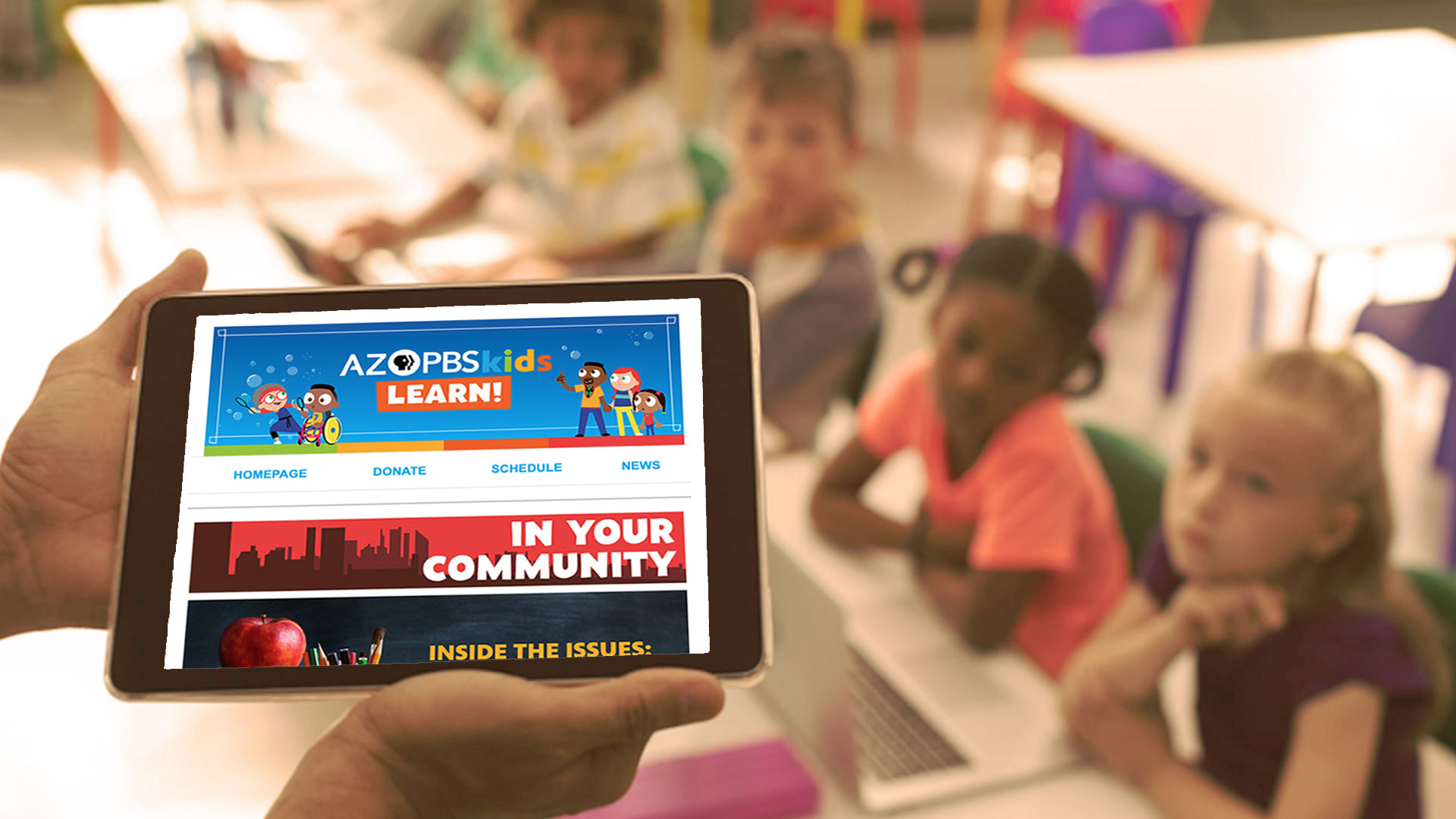 A teacher holds a tablet with the AZPBS kids learn e-newsletter on it