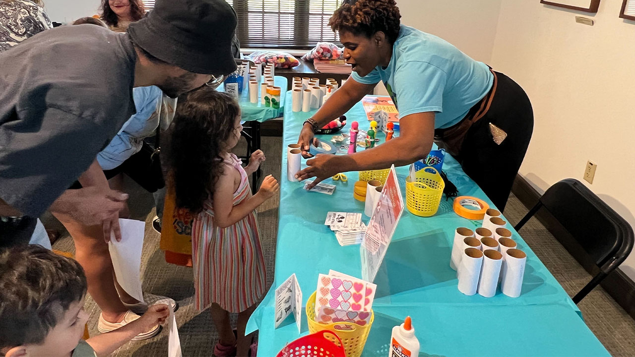 A woman and two children engaged in a shared activity.