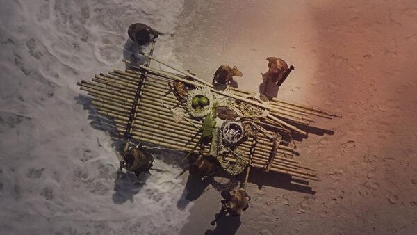 People working and carrying a small raft