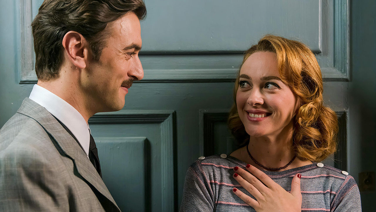 A man and a women looking and smiling at each other