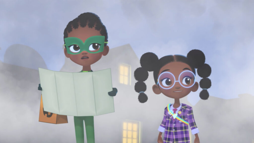 Two girls in colorful costumes hold a treasure map.