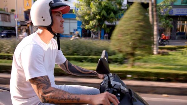 A man riding a scooter down the road