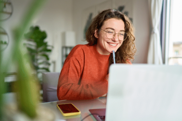 A girl smiling at her computer