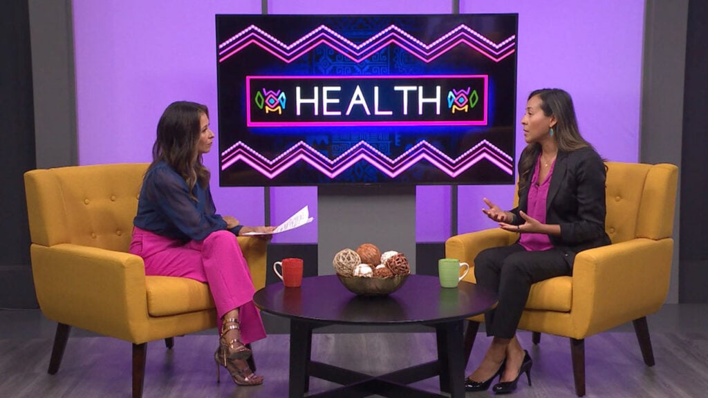 Catherine Anaya sitting down with a guest to discuss women's health
