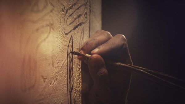 A person writing on a wall