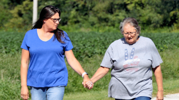 Two women holding hands as they walk