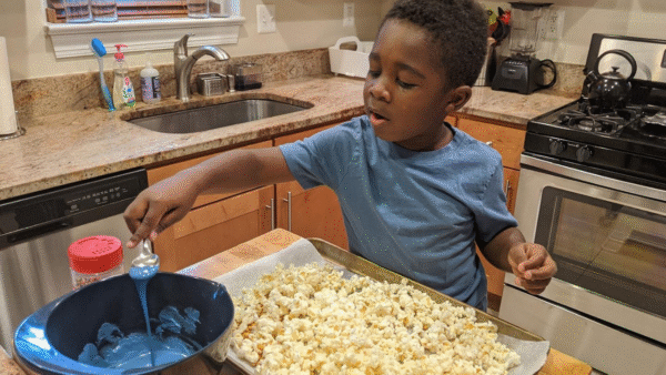 A kid making Molly's candy popcorn