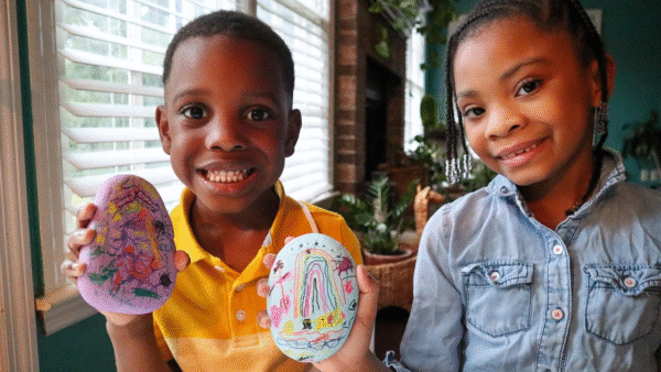 Kids showing off the lucky rocks they made