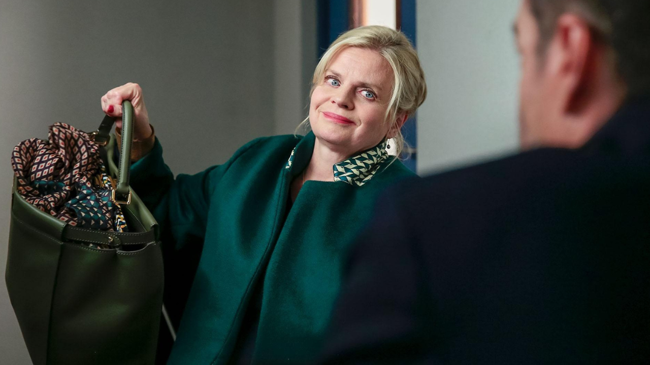 Munch holding up her purse