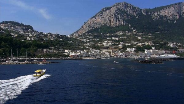 A view of southern Italy with a speed boat out on the water