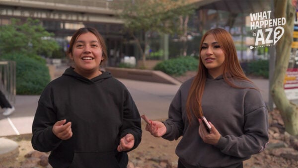 Two students stand outside a school building at ASU