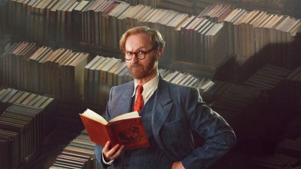 Gabriel Book standing with an open book in his hands