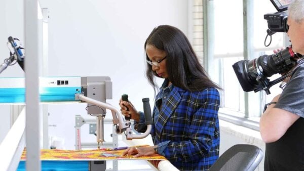 A woman working on a piece of craft