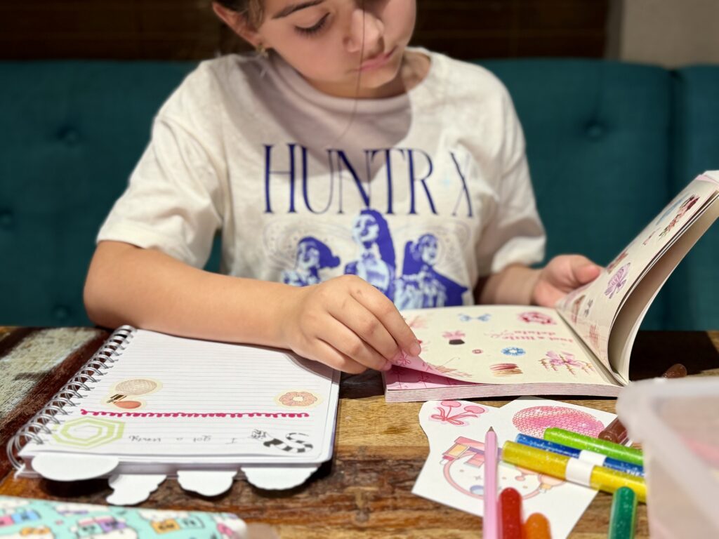 Child looking through a sticker book